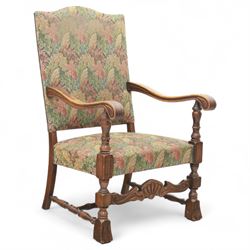 Early 20th-century Jacobean revival open oak armchair, arched padded back, and seat button upholstered  in foliate tapestry style fabric, with scroll carved arms on turned supports, raised on block supports united by turned shaped stretchers 