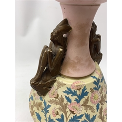A late 19th century Aesthetic Movement Old Hall vase designed by Christopher Dresser, the flared body decorated with stylised flowering vines, leading to a tapering neck and flared rim with twin figural handles (one s/d), and raised upon a circular footed base, with printed mark beneath, H35cm. 
