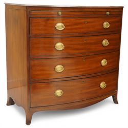 Regency period mahogany bow-front bachelor's chest, shaped top with moulded edge, fitted with brushing slide over four long graduating drawers, each with original pressed brass handle plates, raised on splayed feet 