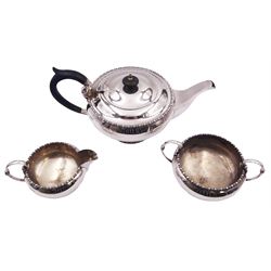 Early 20th century silver three piece tea service, comprising teapot with ebonised handle and finial, twin handled open sucrier, and milk jug, each of bellied form with bead and dart band to rim and foot, hallmarked Walker & Hall, Sheffield 1918, approximate gross weight 33.64 ozt (1046.5 grams)