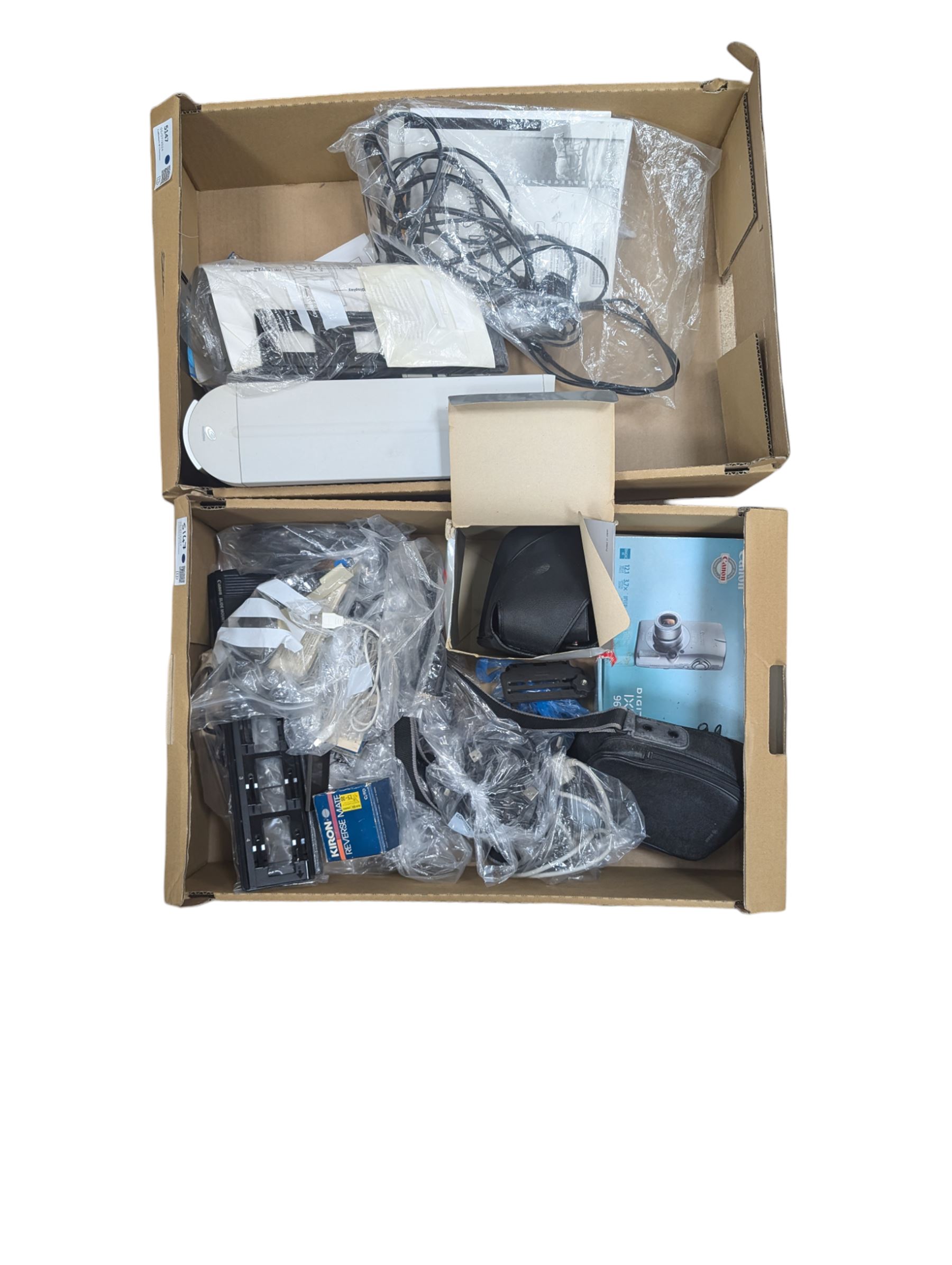 Collection of predominantly Canon camera accessories, including CanonScan FS40000US, cases, straps, cables, etc 