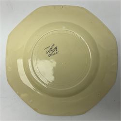 Clarice Cliff Bizarre for Newport Pottery Orange Roof Cottage pattern plate, circa 1932, hand painted with a stylised cottage and bridge landscape with yellow, orange and black banding, black printed mark beneath, D22cm 