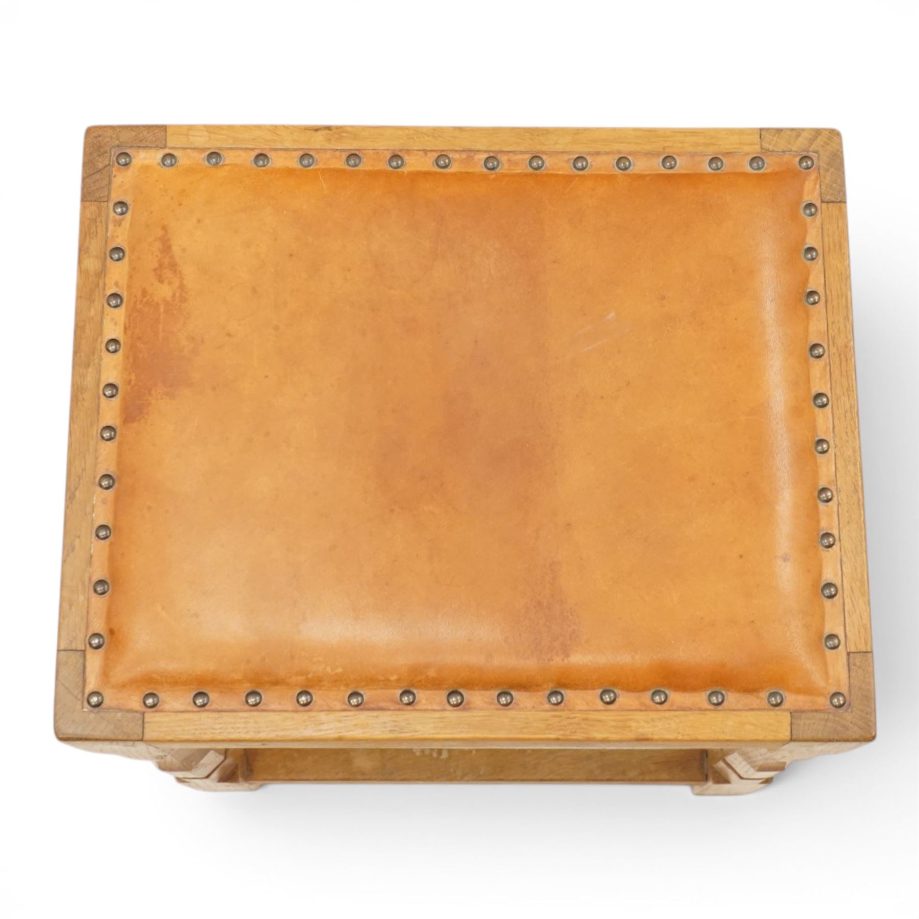 Mouseman - oak dressing table stool, the rectangular tan leather padded seat with studwork border, raised on octagonal supports united by box stretcher, carved with mouse signature, by the workshop of Robert Thompson of Kilburn