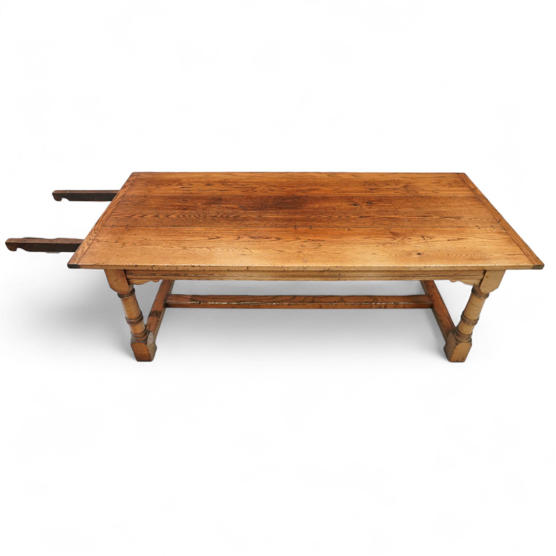 Late 20th century oak refectory table in 17th century style, with plank top and end leaf, raised on ring turned baluster legs with square feet, joined by conforming stretchers (260 cm extended)