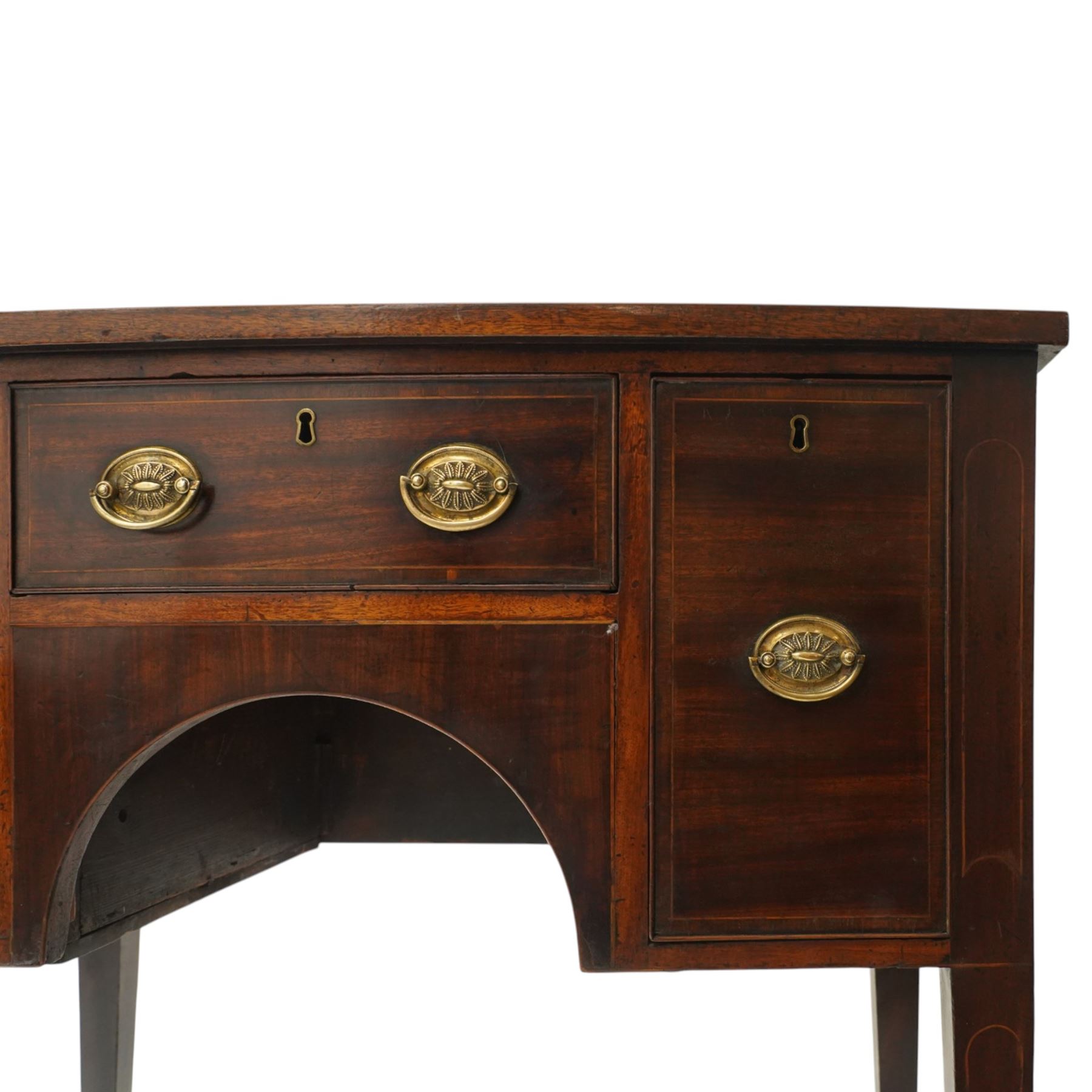 Small late 18th century inlaid mahogany sideboard, with bow fronted top with crossbanded edge, central drawer flanked by a drawer each side, kneehole cut out, raised on square tapering supports terminating in spade feet