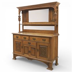 Arts and Crafts oak mirror back sideboard, the bevelled rectangular mirror set within a back with foliate carved panels, with turned baluster and knopped supports, upon a base with moulded top above three drawers  and three cupboard doors, two with carved foliate detail, upon four shaped bracket feet