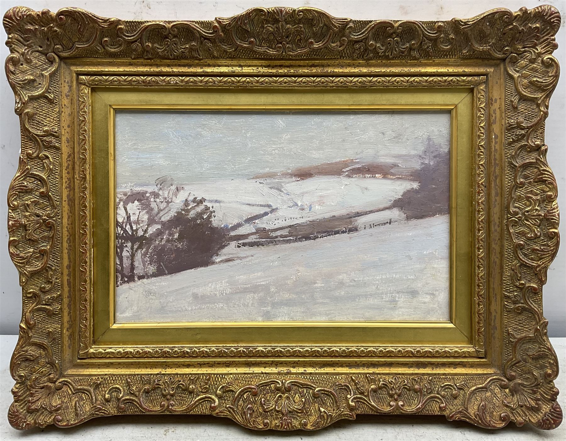 John Sergeant (British 1937-2010): Winter Landscape, oil on artist's board unsigned 19cm x 31cm
Provenance: from the artist's wife Carolyn's studio sale. Born in London, Sergeant moved to Faversham in Kent after his family was bombed out during World War II. He entered the Royal Academy Schools in 1959, where he won a Drawing Prize in 1961. After graduating, Sergeant taught part-time at art schools in Kent and worked on commissions including book jacket designs and a series of ‘room-portraits’ of interiors. He moved to Wales in 1983, and held the first of three exhibitions at the Maas Gallery in Mayfair in 1986. In 1989 the Prince of Wales (now King Charles III) asked Sergeant to contribute drawings to his book Visions of Britain; two years later Sergeant accompanied the Prince on an official visit to Prague, resulting in an exhibition. 
