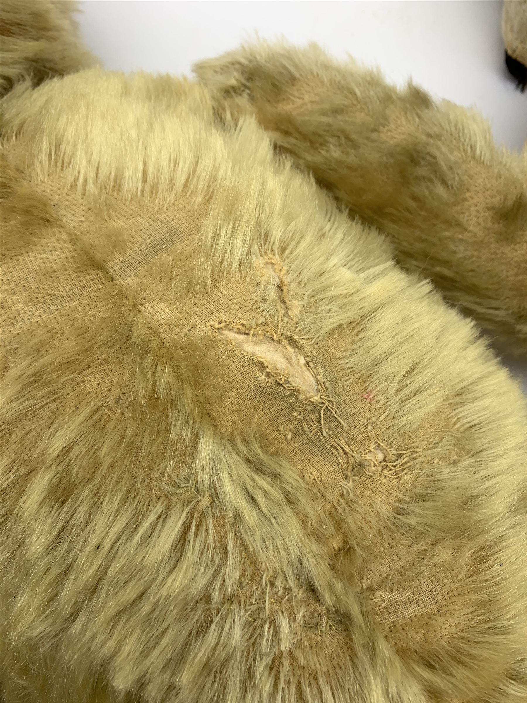 Four Chiltern teddy bears 1930s-50s, including white one with revolving head, glass type eyes, vertically stitched nose and mouth and jointed limbs with felt paw pads H16.5