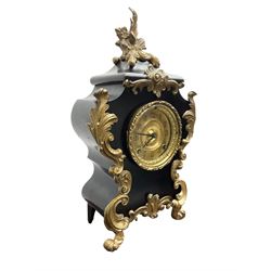 Ansonia - American late 19th century steel cased 8-day mantle clock in a Rococo case with decorative brass mounts, brass dial with Arabic numerals, steel hands and a repousse dial centre, twin train striking movement sounding the hours and half hours on a gong. with pendulum and key.