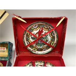 Quantity of boxed oriental collectibles to include sake cups, tea set, painted Chinese balls and fan (4)