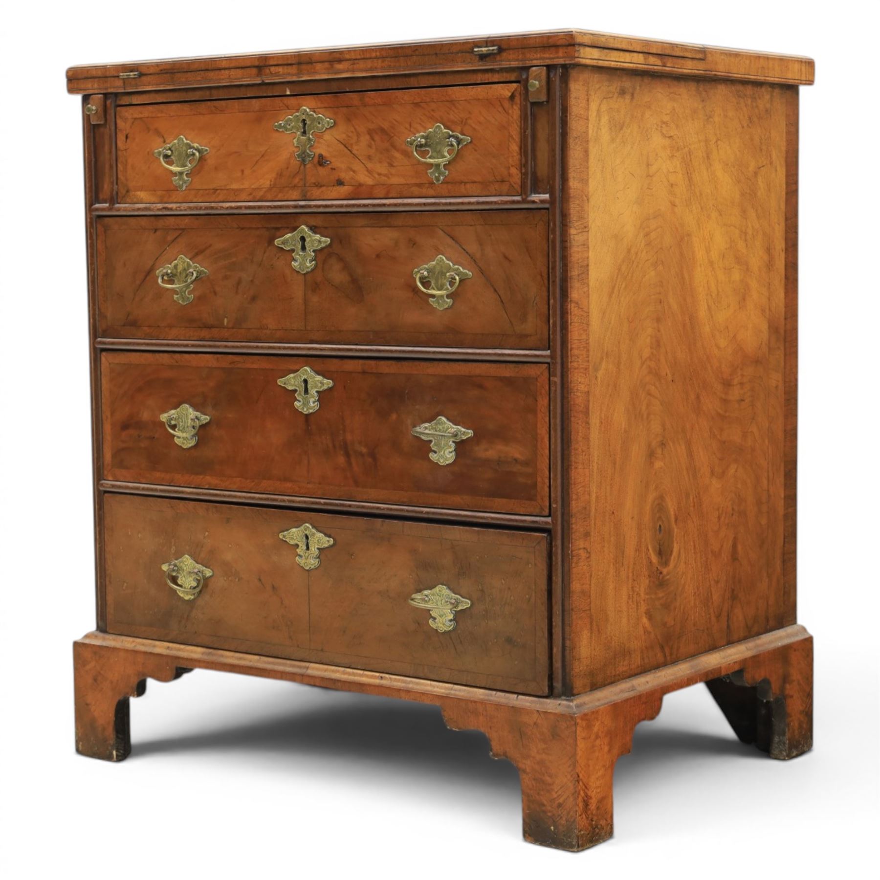 Early 20th century Georgian design figured walnut bachelor's chest, with half fold over top and lopers, over three drawers with pierced brass handles and escutcheons 