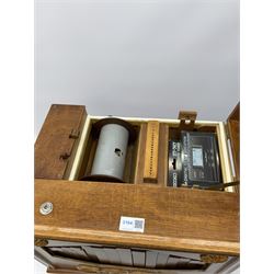 Small scratch built wooden John Smith style twenty-note busker organ with thirteen paper music rolls, other paper music and soft toy monkey