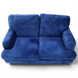 Howard design - two-seat sofa upholstered in blue fabric, traditional shape with rolled arms, on walnut finish turned feet with brushed metal cups and castors