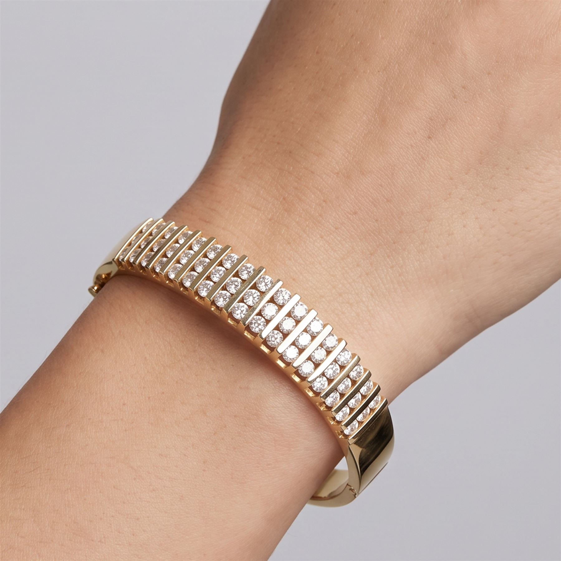 14ct gold diamond hinged bangle, fifteen rows each channel set with three round brilliant cut diamonds, stamped 14K, total diamond weight approx 3.15 carat