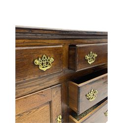 George III country oak dresser base,  rectangular top over with three central drawers flanked by two drawers and two panelled cupboards, each with moulded fronts, on stile feet