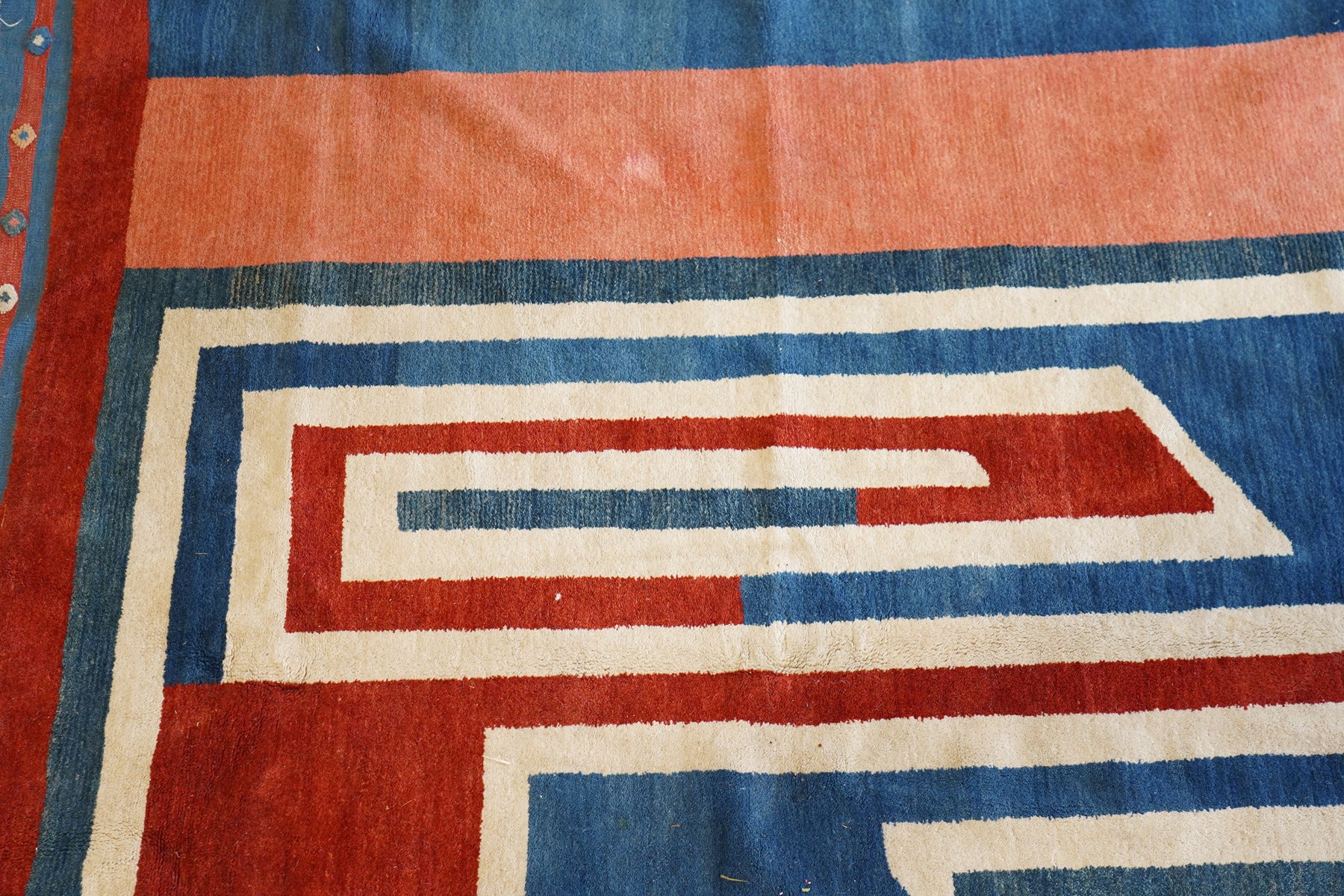 20th century Anatolian Turkish indigo ground rug with Art Deco inspired abstract design in tones of ivory, crimson and coral