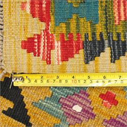 Afghan Maimana flatweave kilim runner, central field features large bold nested diamond motifs and stylized geometric lozenge patterns on olive purple, blue, and green tone ground, border stripe in mustard ground, and fringe