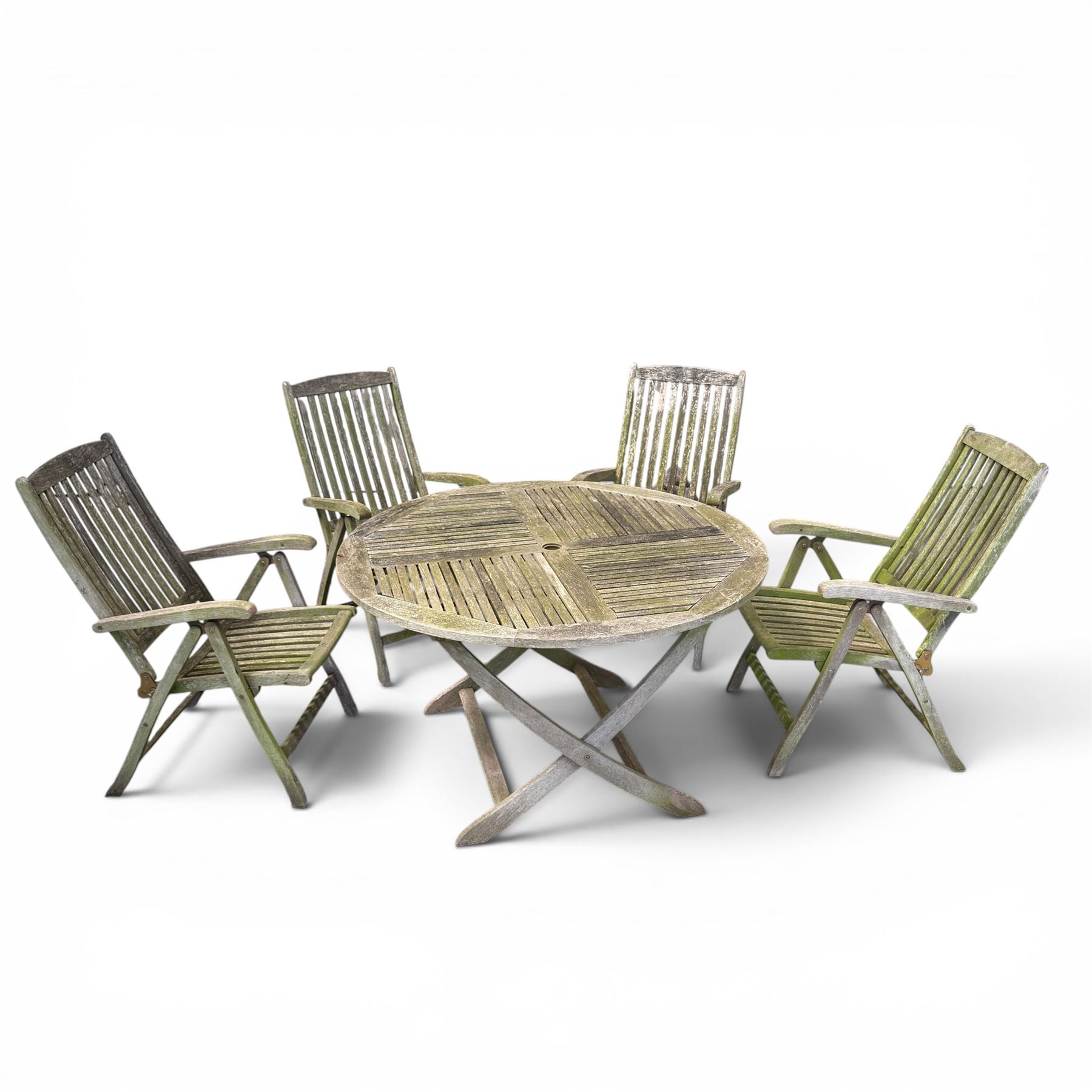 Five piece teak garden dining set, comprising circular folding table and four folding armchairs, with slatted seats and backs in a weathered finish