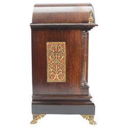 Winterhalder and Hoffmeier - German 8-day three train Edwardian oak cased mantle clock, with a break arch pediment, brass sound frets to the sides and conforming glazed door beneath, with flanking reeded pilasters on a stepped plinth raised on paw feet, sheet brass dial with fretted spandrels and matted dial centre, silvered chapter with Roman numerals, gothic steel hands and subsidiary dials for pendulum regulation and chime select, going barrel movement, chiming the quarters and striking the hours on nine coiled steel gongs. With pendulum and keys.