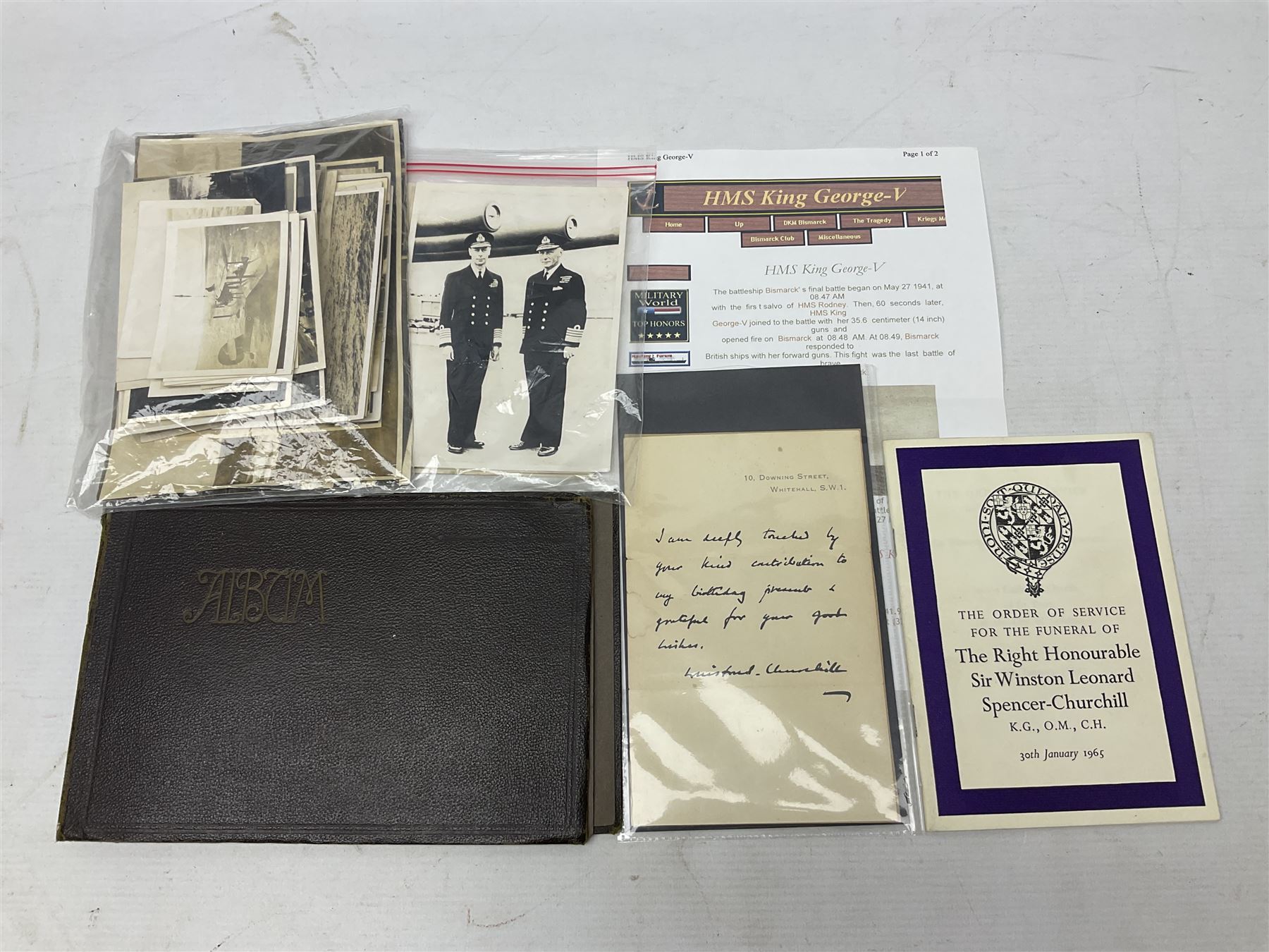 Disbound WW2 album relating to the battleship HMS King George VI containing over fifty various size loose photographs of the ship in action, guns firing, crew members, aircraft, two of George VI on board, three of Winston Churchill on board, official 1942 Christmas messages including Franklin Roosevelt etc; together with unrelated printed letter on 10 Downing Street notepaper from Winston Churchill; and Order of Service for Churchill's funeral at St. Paul's Cathedral 30th January 1965