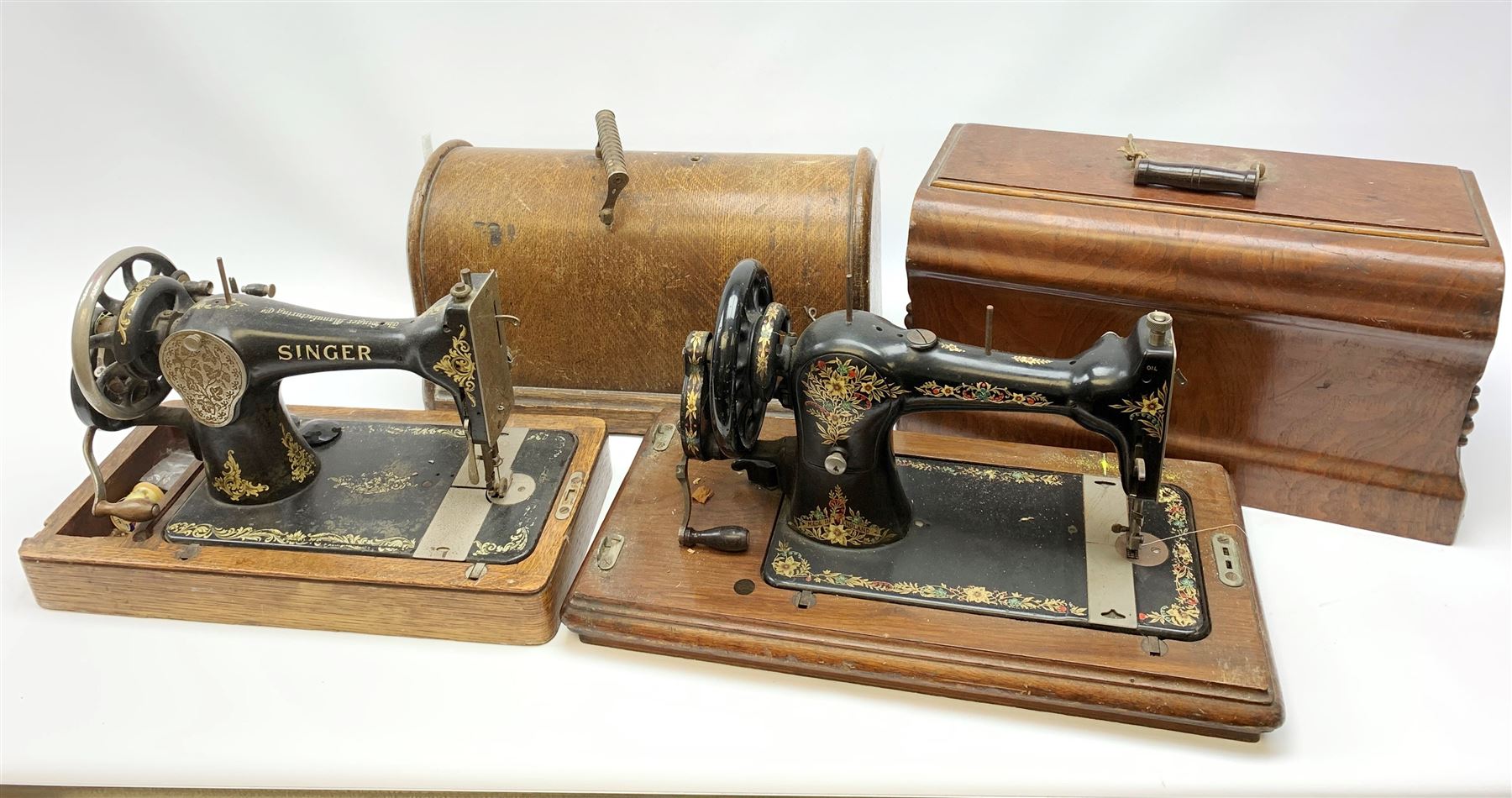 Two vintage sewing machines, the first marked Federation, in mahogany case, the second marked Singer, in oak case. 