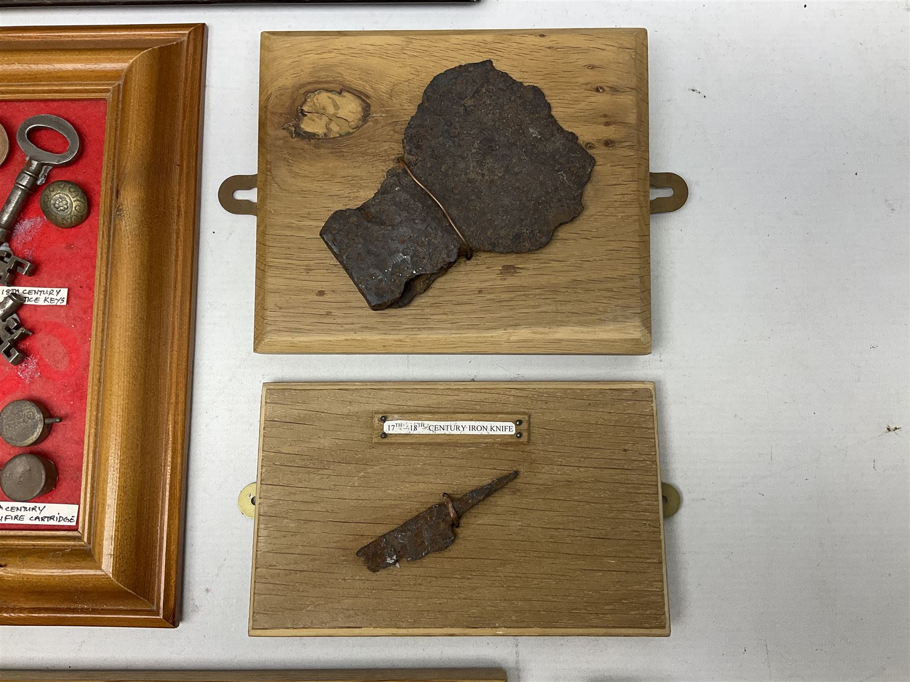 Collection of metal detecting finds and antiquities, housed on five display boards and some loose, to include coins, keys, axe head etc 