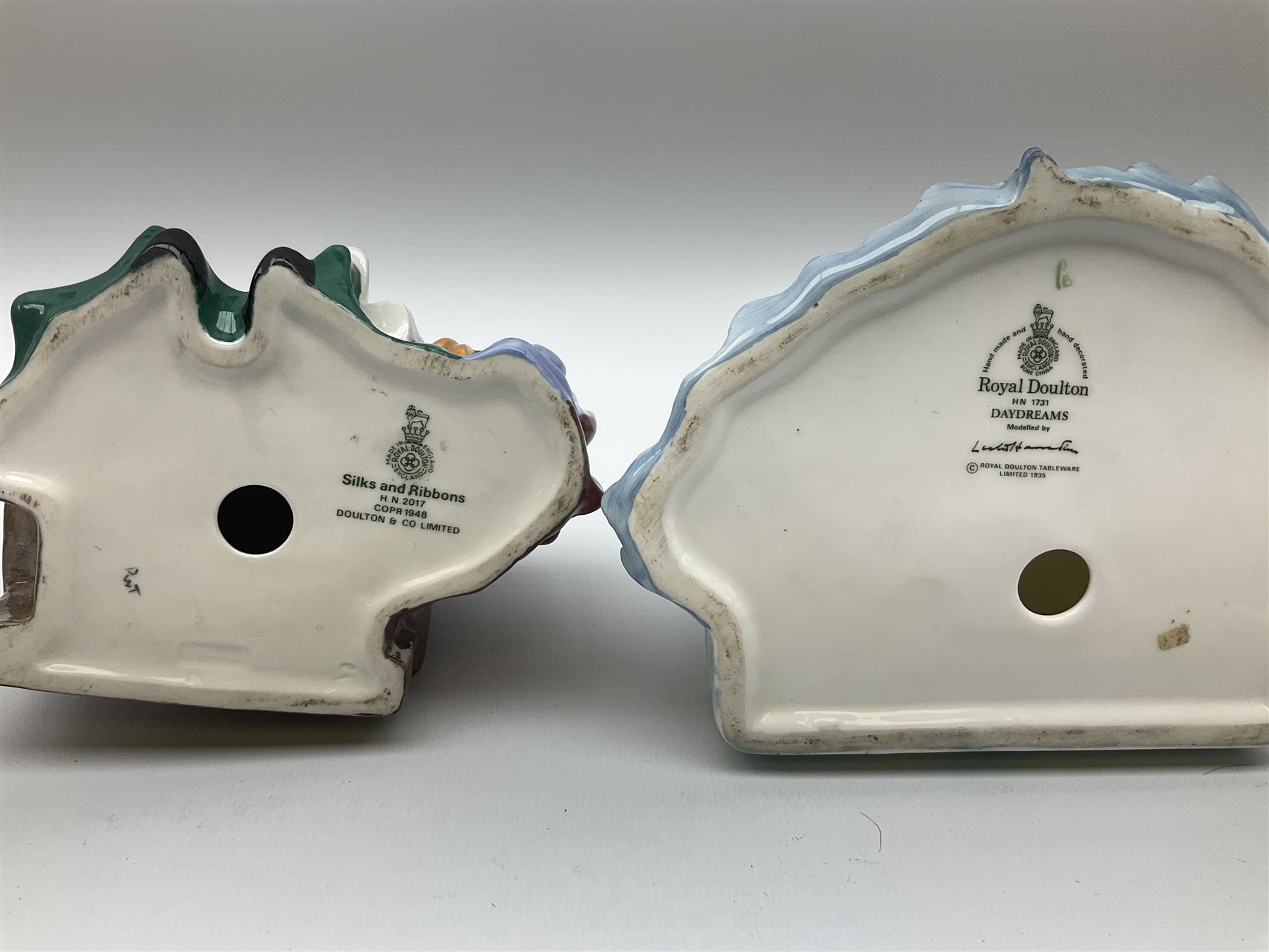 Group of figures, comprising six Royal Doulton examples, Daydreams HN1731, Silks and Ribbons HN2017, Tom Sawyer HN2926, Marie HN1370, Bo-Peep HN1811, and Tinkle Bell HN1677, together with a Dresden type 'lace' example, and a Coalport 'Swiss Cottage', (8)