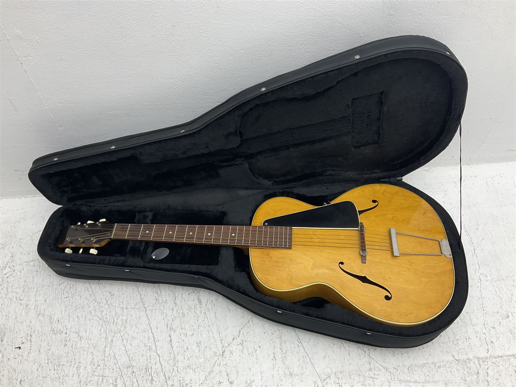 1950s acoustic guitar with f-holes and pickguard L105cm; black fur lined hard carrying case