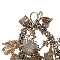 Silver charm bracelet, with seventeen charms including motorbike helmet, enamel toby jug, piano, etc