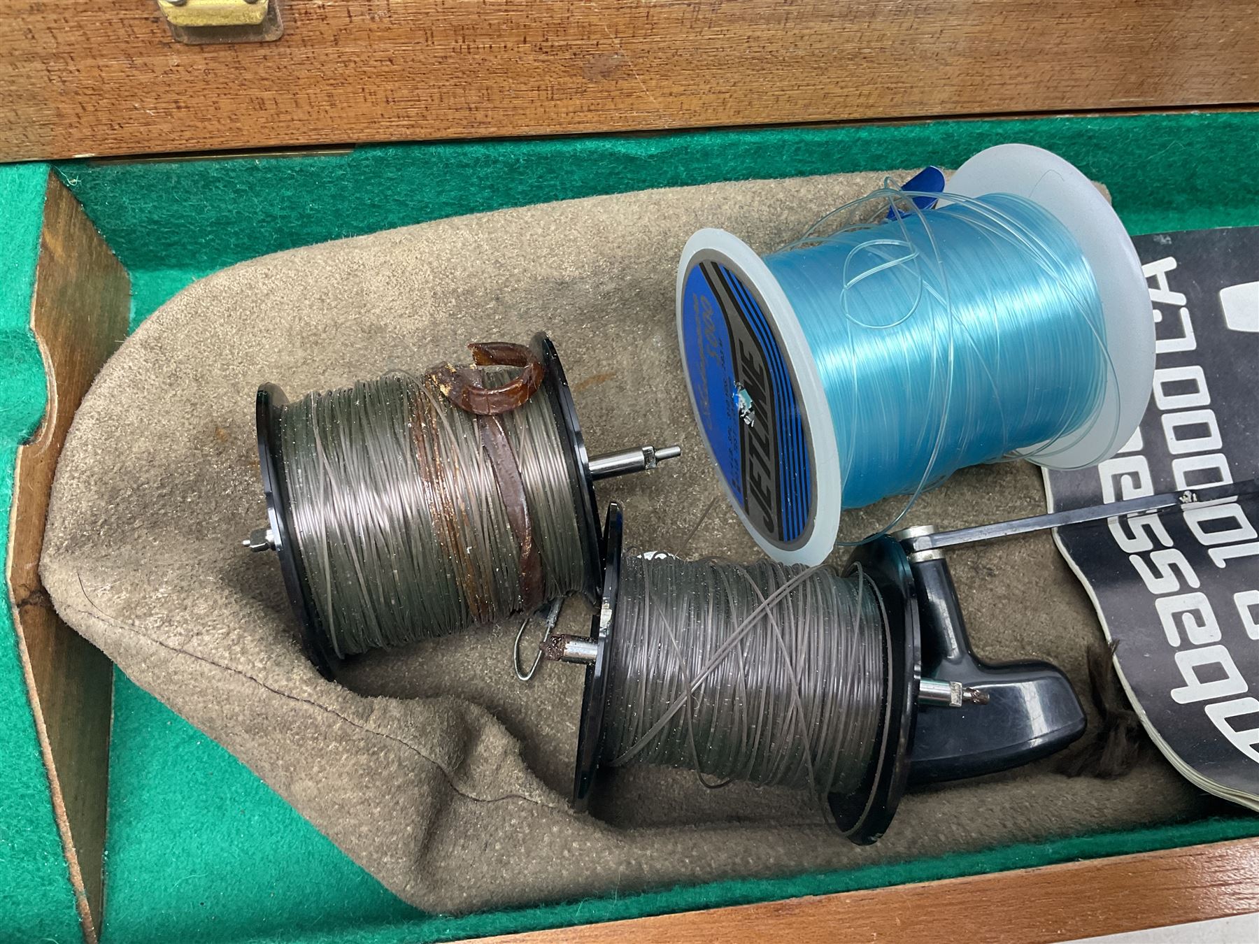 Four Abu fishing reels, comprising Ambassadeur 9000, Ambassadeur 7000, Ambassadeur 5500 and Ambassadeur 6500, together with additional line, hardy fishing bag and two wooden boxes