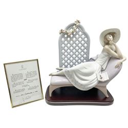 Lladro figure, Garden of Dreams, modelled as a woman reclining in front of trellis of flowers on a mahogany base, limited edition 3129/4000, sculpted by  José Puche, with original box, no 7634, year issued 1994, year retired 1996, H32cm