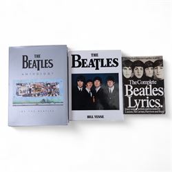 The Beatles memorabilia, including 1964 Fan Club patch, framed with a black and white picture of the band, a further framed black and white picture displayed with Strawberry Fields Forever single, The Beatles Anthology, biographies and other books, two CDs, mug, etc