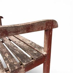 Teak garden bench, with slatted seat and spindle back, shaped armrests, finished in weathered red painted finish.
