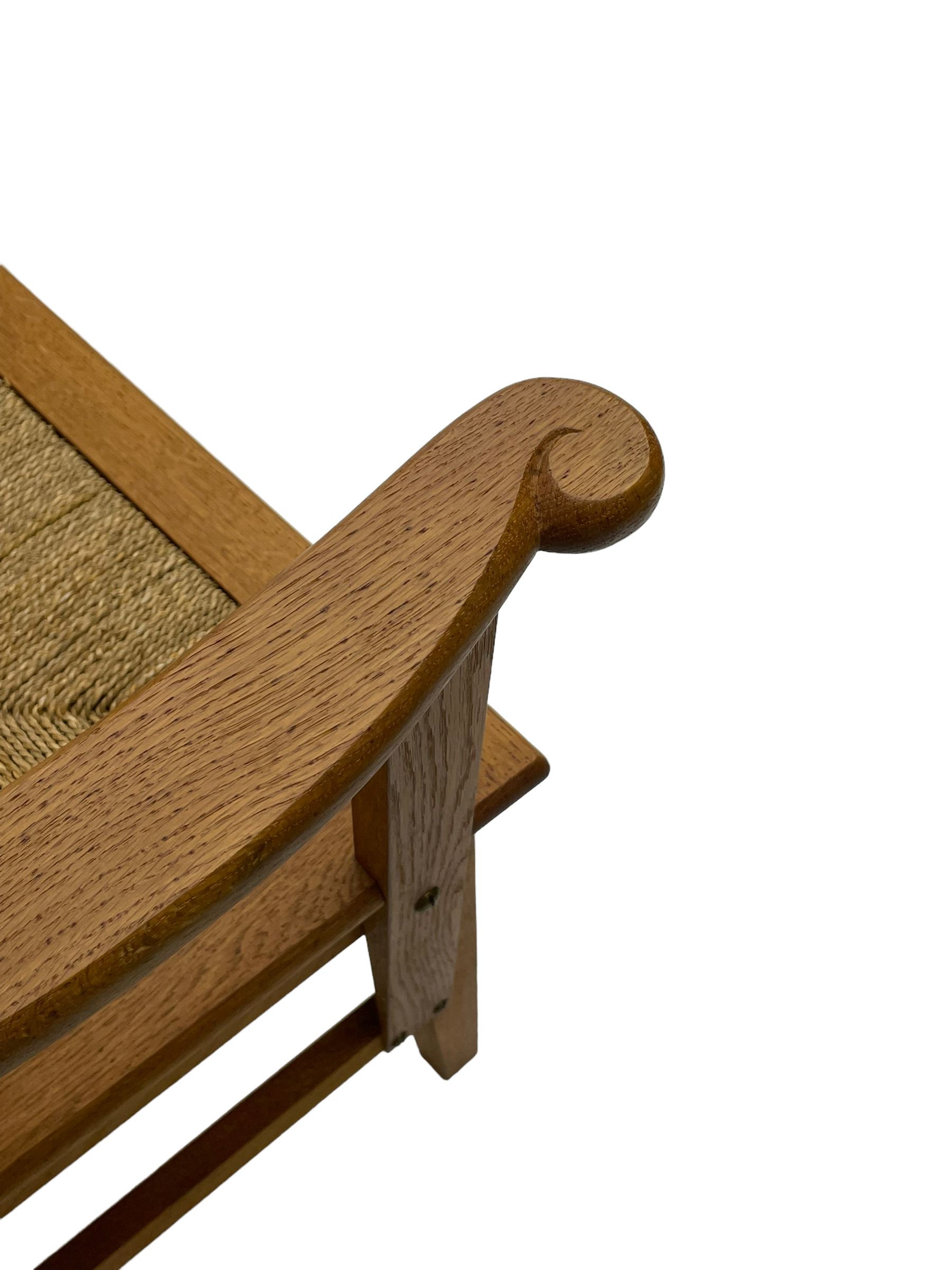 Reynold Eunson (1932–1978) for David Munro Kirkness, Kirkwall, Orkney - oak framed Orkney chair, woven straw canopy back, drop-in rush seat, the arm terminals carved with scrolls, on square tapering supports joined by plain stretchers, the front rail inscribed with makers marks