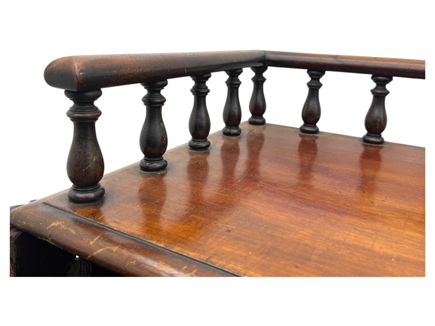 Large Victorian mahogany Registry/Dickens’ desk, spindle gallery top, one side with five small drawers and the other with blind cupboard drawer, revealing pigeon holes with scroll carved locking side bars on either side, above a hinged and leathered writing slope with three drawers and pigeon holes underneath, above a central locking drawer with key, the pedestals each with four drawers and  turned knob handles, separates into four parts for transport