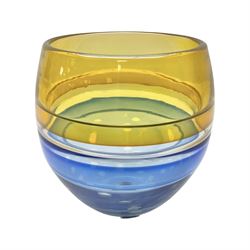Stuart Akroyd glass vase, yellow banded top and blue lower section with bubble inclusions, with sticker and engraved signature beneath, H17cm