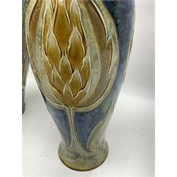 Early 20th century Royal Doulton stoneware vase, decorated with a stylized floral design below a wavy rim, monogrammed B.N, possibly for Bessie Newbery, H28cm, together with an early 20th century glazed jug, heavily carved throughout (2)