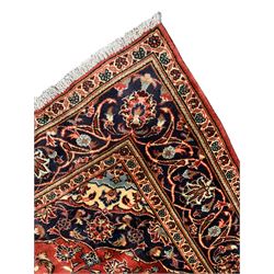 Persian Ardakan crimson ground rug, the field with shaped floral design medallion surrounded by curled leafy branches, scrolling border with stylised plant motifs