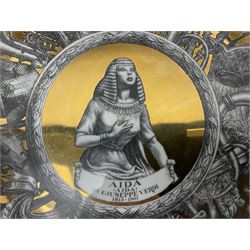 Three Fornasetti plates from the Melodramma series, each depicting a operatic portraits within a border of operatic emblems on gilt ground, with printed mark beneath, D25cm 