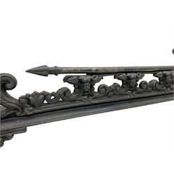 Late 19th century ornate cast iron fire fender, decorated with foliate scrolls