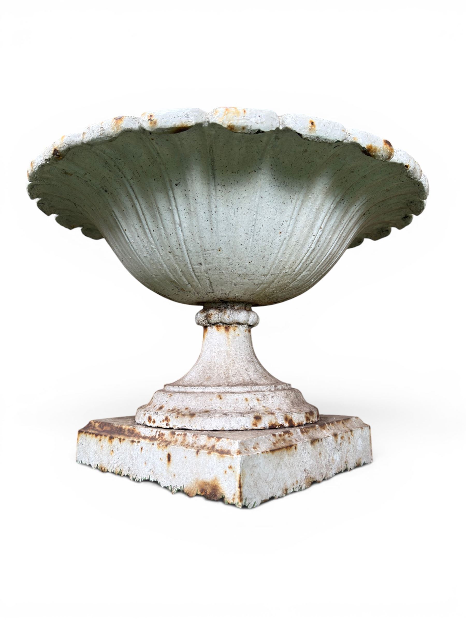Coalbrookdale - pair of 19th century cast iron petal rim urns, squat form on square plinth, finished in distressed white paint, design registration number 133334, first registered 19 september 1860, number 19 in the Coalbrookdale Castings Catalogue (see illustration)