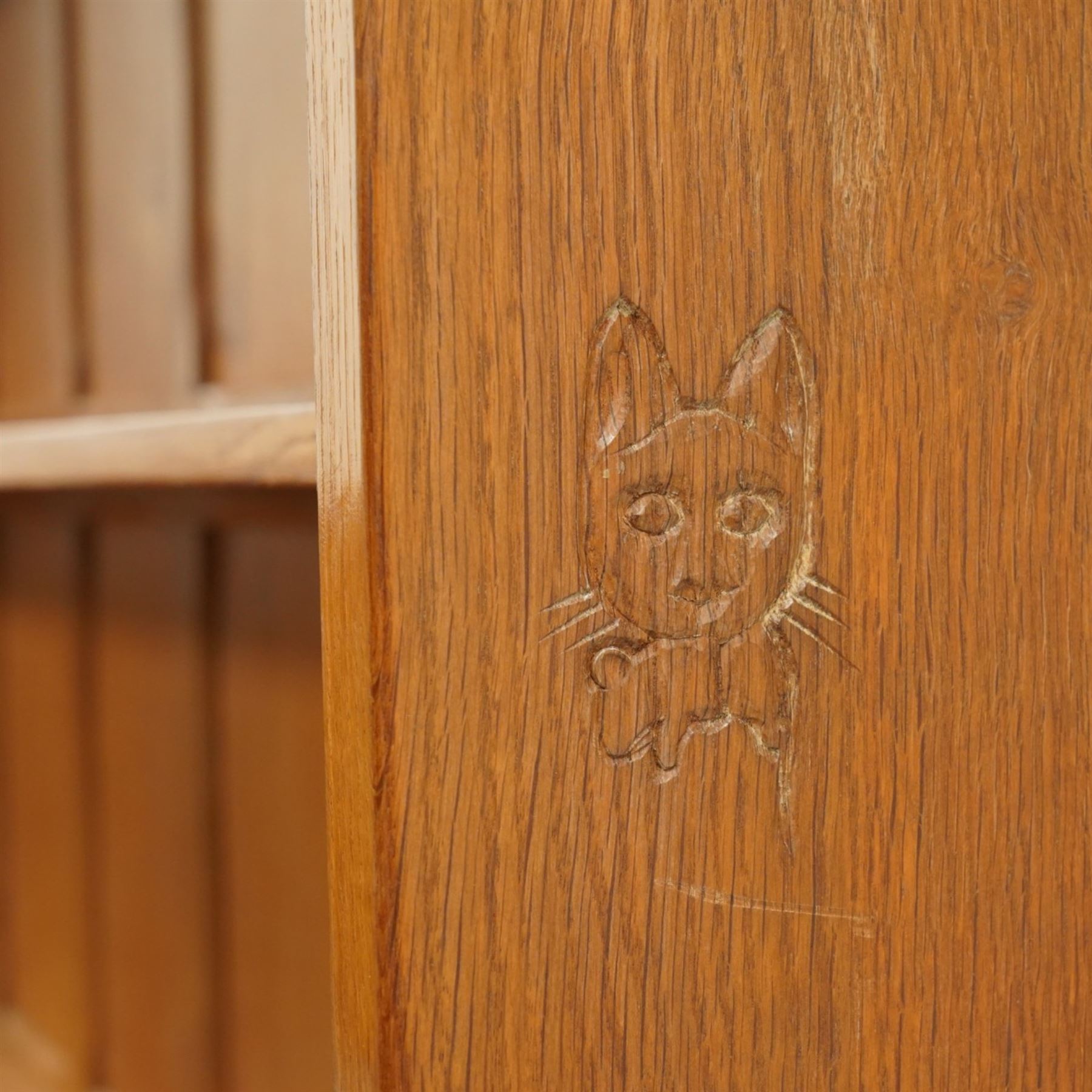 Cat and Mouseman - adzed oak dresser and plate rack, plate rack with two delf rack, panelled back and shaped uprights, above a base with two short drawers and turned wooden handles, panelled cupboard doors and sides, raised on a plinth base, with carved Cat and Mouseman signature, by Lyndon Hammell of Harmby