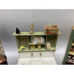 Collection of miniature dolls house kitchen ware furniture and accessories, to include illuminated period cooker, wash house sink, pair of kitchen units with various preserves etc, 1930/40s style veg prep table with duck, wall racks, chairs, various foodstuffs etc