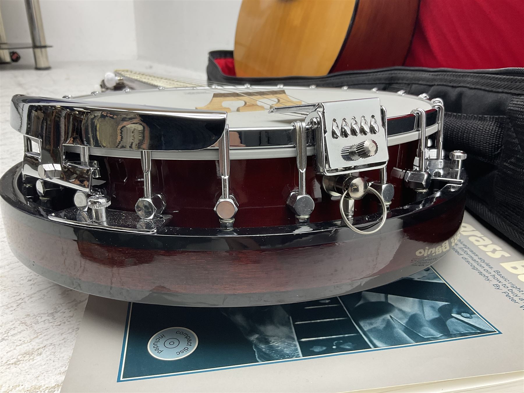 Rally five-string banjo with mahogany solid back L101cm in soft carrying case; and Brunswick Model BF200 acoustic guitar L103cm; with small quantity of instructional DVDs and booklets