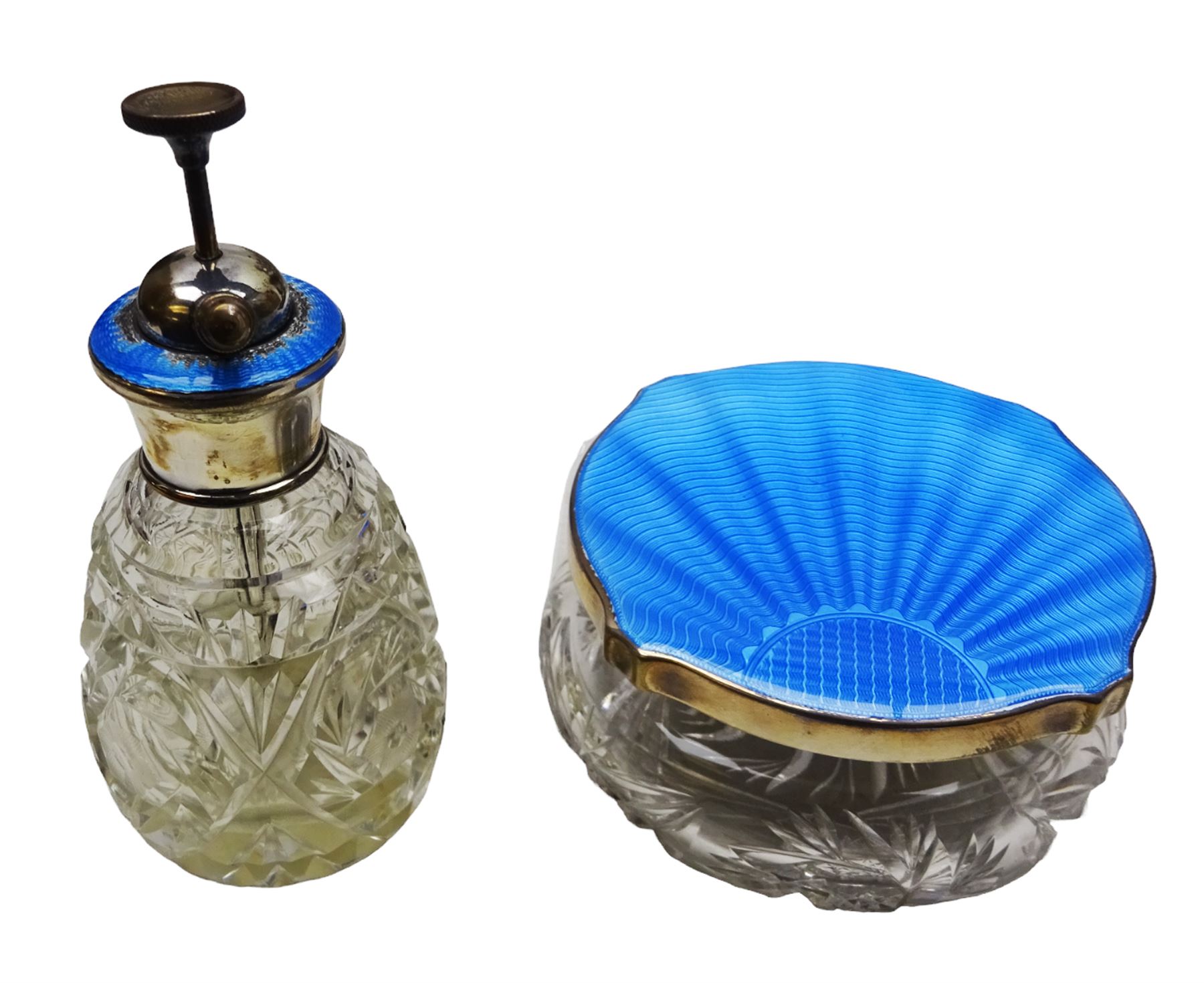 Art Deco thirteen piece silver mounted blue guilloche enamel dressing table set, comprising two hair brushes, two clothes brushes, hand mirror, two cut glass jars, buffer and a cut glass scent bottle, hallmarked J W Tiptaft & Son Ltd, Birmingham 1930 and 1932, and a silver handled manicure set, hallmarked Daniel Manufacturing Company, Birmingham 1930, with a pair of base metal scissors, each contained within three original fitted cases with black and cream silk and velvet lined interiors, one with removable mirror