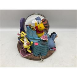 Five Disney Winnie The Pooh snow globes, to include Pooh and Piglet Sailing, Pooh's Grand Adventure and Blustery Day, together with The Walt Disney Classic Waterglobe collection globe and group Tigger, Winnie and Piglet figure under dome, all with boxes (7)