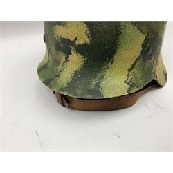 Fully restored German steel helmet, the camouflage painted exterior with two decals and replacement leather liner
