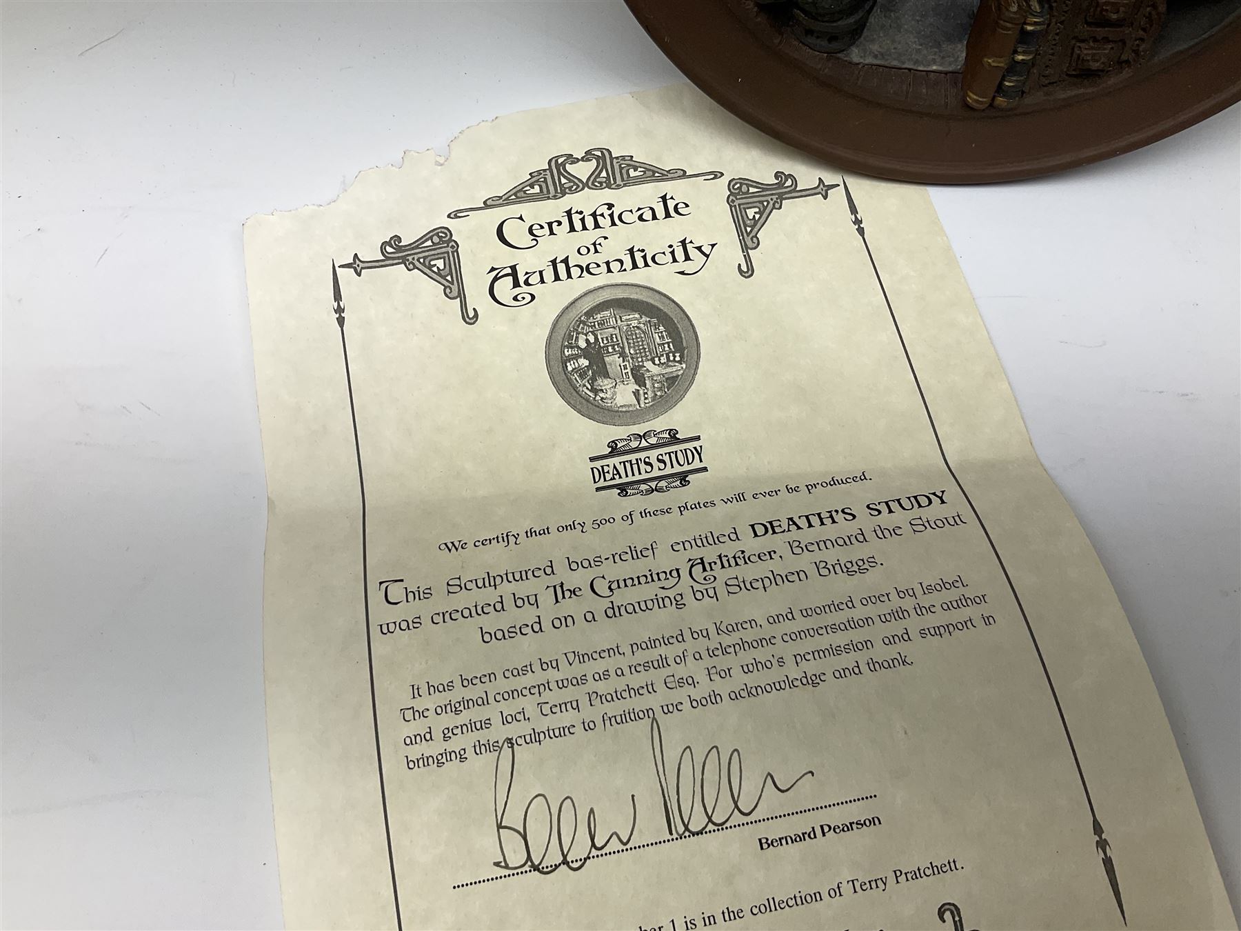 Two Terry Pratchett Discworld limited edition sculptured bas-reliefs, designed by Clarecraft, comprising Death Study created by 'the cunning artificer, Bernard the stout', 132/500 and The Hogfather, created by 'the cunning artificer, Bernard the stout', 132/500, both with certificates of authenticity.   