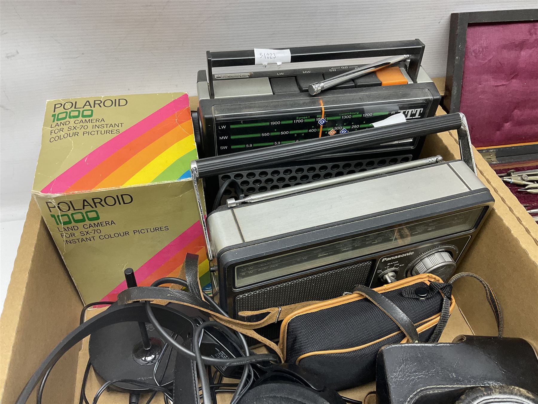 Johnson Bros Indies pattern tea and dinner wares, painted metal female bust on wooden plinth, three radios including one Roberts, Zenit B camera body, Polaroid 1000 land camera, Lorus wristwatch, and other ceramics etc, in four boxes