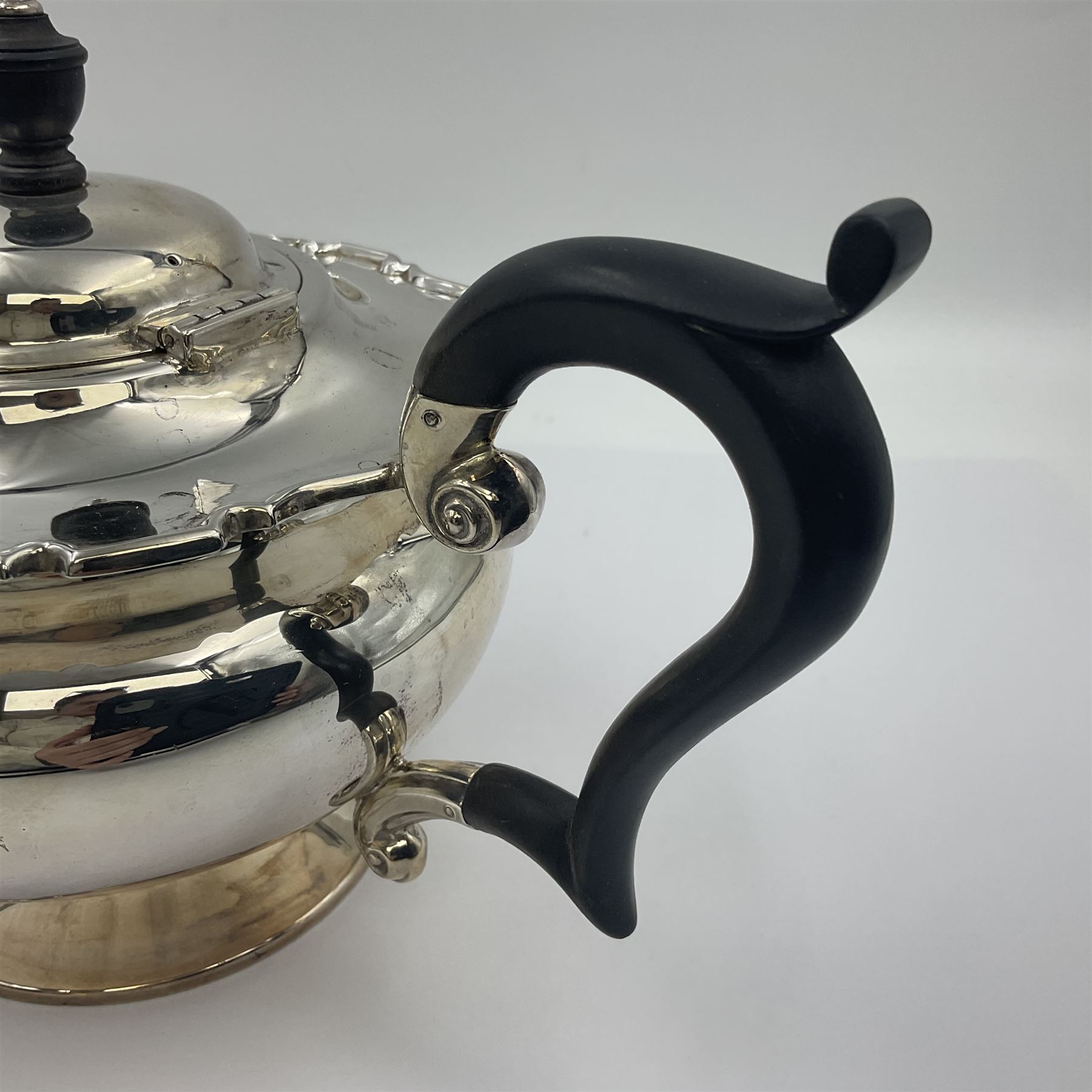 1920s five-piece silver tea service, comprising teapot, coffee pot, hot water pot, twin handled open sucrier and milk jug, each of squat circular form with shaped rim, the teapot, coffee pot and hot water pot each with ebonised handle and finial, the sucrier and milk jug with acanthus capped scroll handles, all upon circular foot, hallmarked R F Mosley & Co, Sheffield 1926 & 1927, tallest H24cm